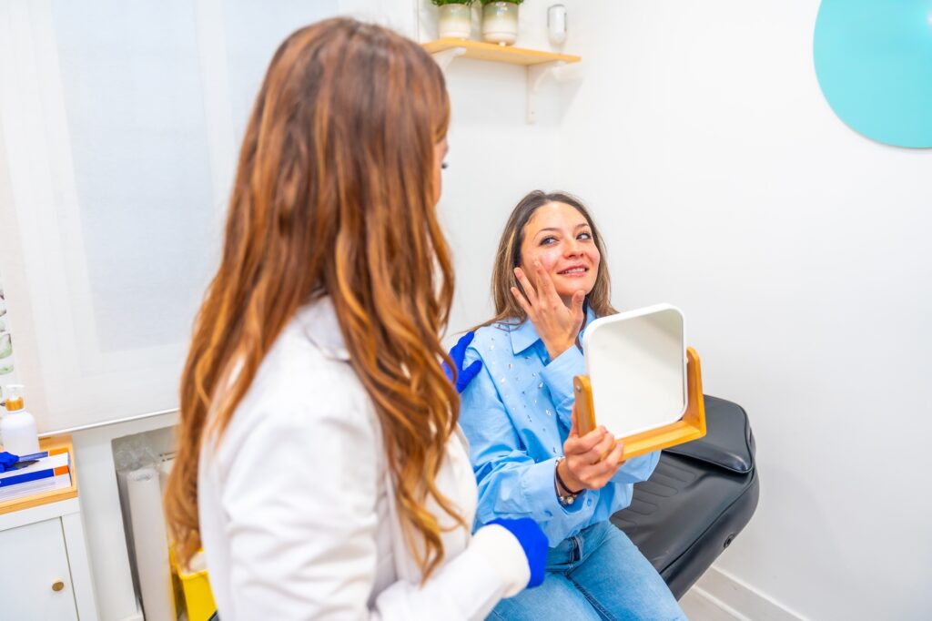 Woman sitting in med spa office talking to provider about lip filler near Winter Garden, FL