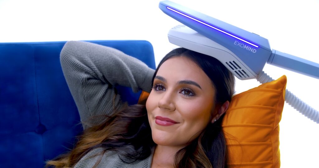 Happy brunette woman at Lumina Vein & Aesthetics receiving Exomind for depression and anxiety treatment in Windermere.